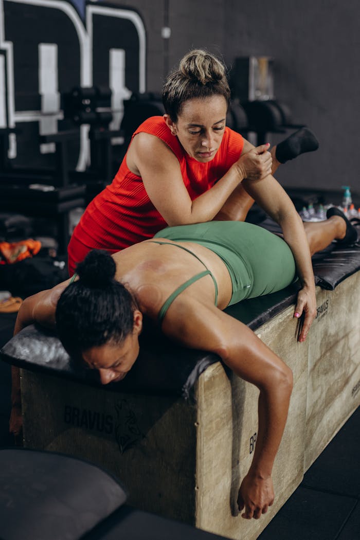 Focused massage therapist working on a client's back for muscle relaxation and recovery.