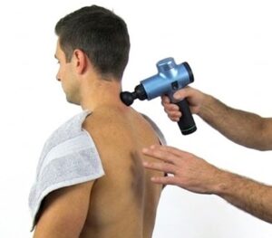Patient receiving percussion therapy at Tam Physio and Rehab