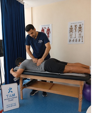 Physiotherapist treating a patient with back pain at Tam Physio & Rehab Clinic